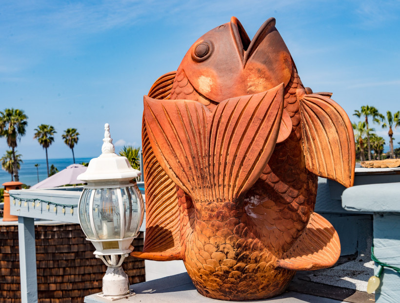 large sculpture of a fish on a dock