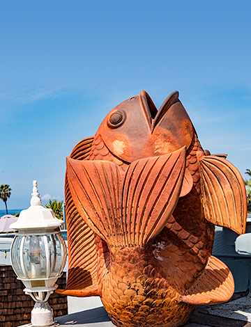 orange fish statue next to white lamp