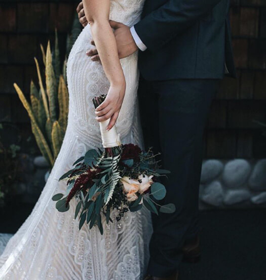 close up of a bride and groom holding each other close