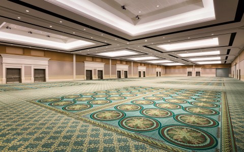large ballroom with green carpet and inset lighting
