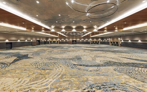 large ballroom with blue carpet and inset lighting