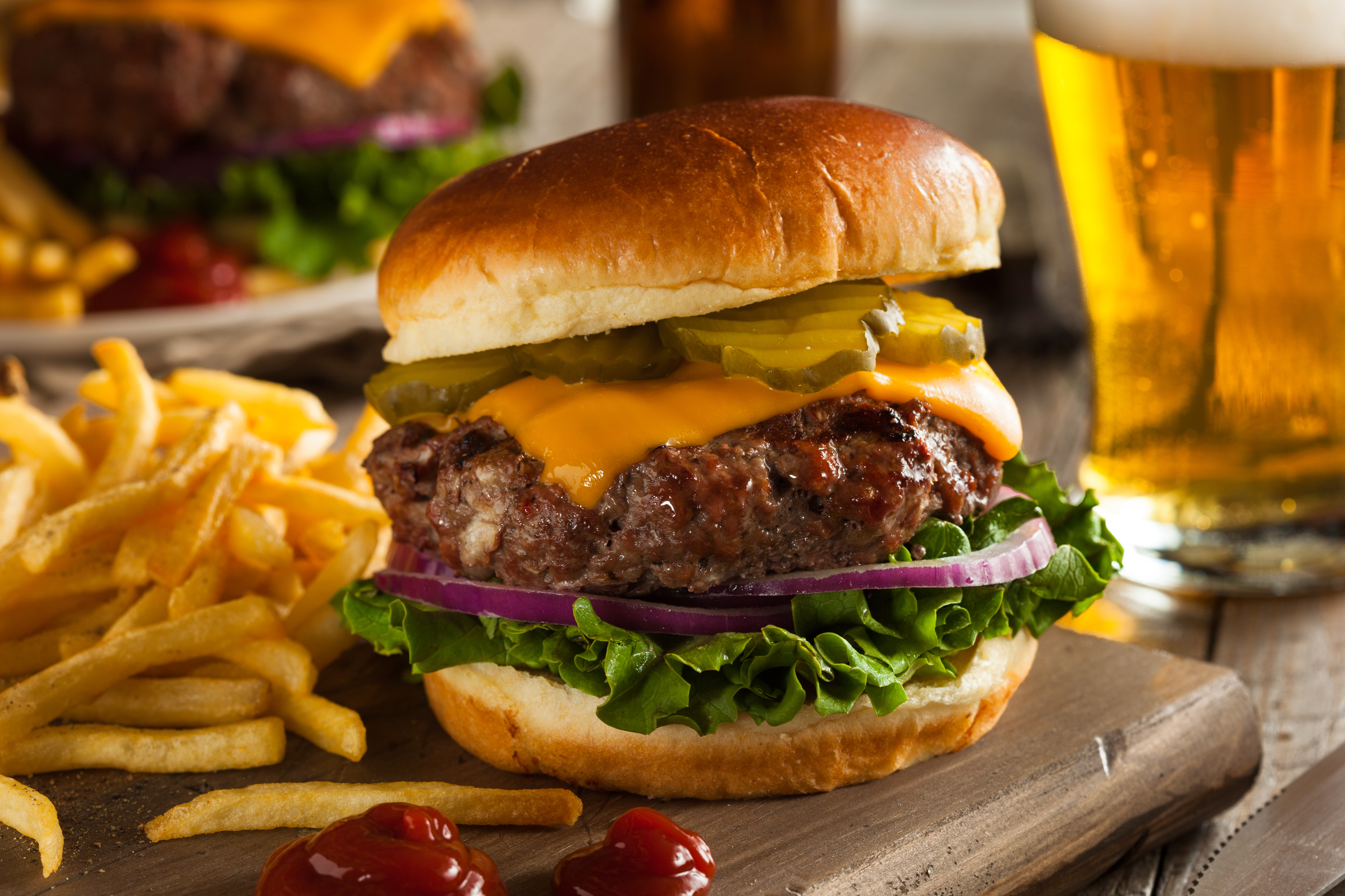 in-suite dining hamburger with fries and a beer