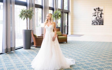 bride posing in her wedding dress in the lobby 