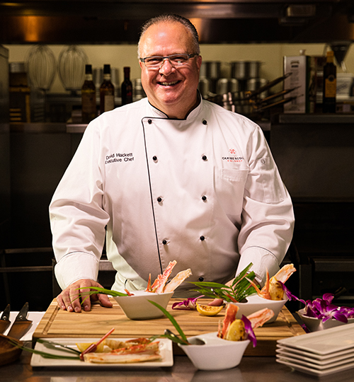 portrait of chef dave solo in the kitchen with food in front of him