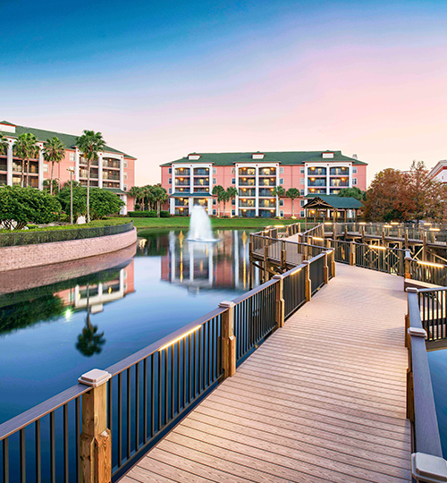 facing pink buildings from a dock during sunset