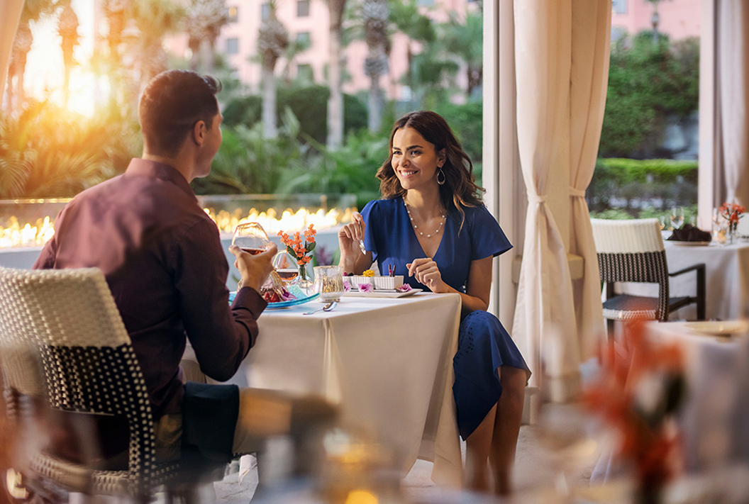 couple having dinner in a restaurant while smiling