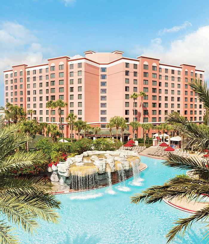 aerial view of the caribe royale pool with a waterfall and buildings behind it