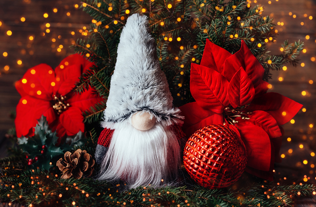 holiday gnome with red ornaments and poinsettias