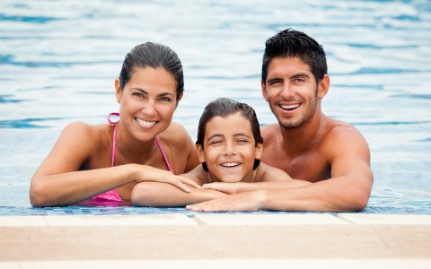 couple with child in pool