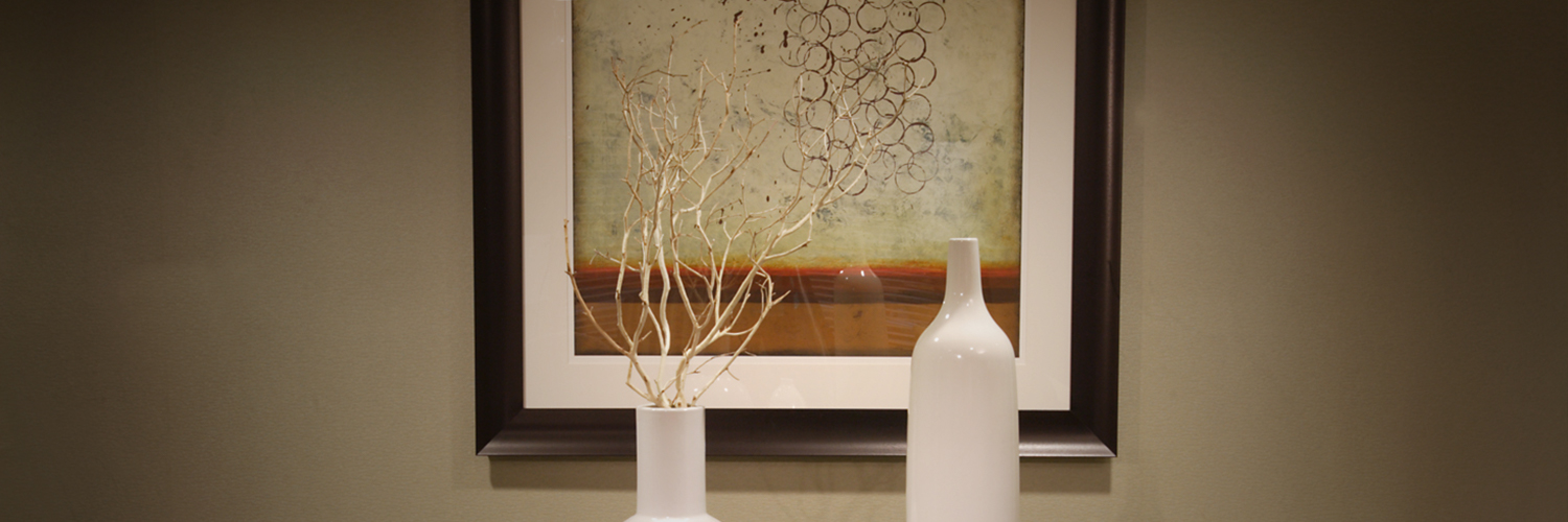 two white vases in front of abstract art piece