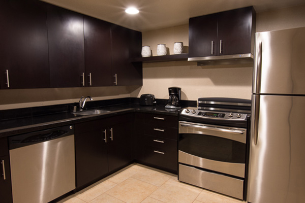 full kitchen with silver appliances and dark brown cabinets