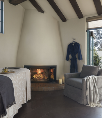 Spa room with a fireplace and robe next to it