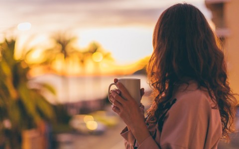 woman enjoying a cup of coffee outside