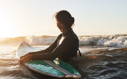 woman surfing in the early morning