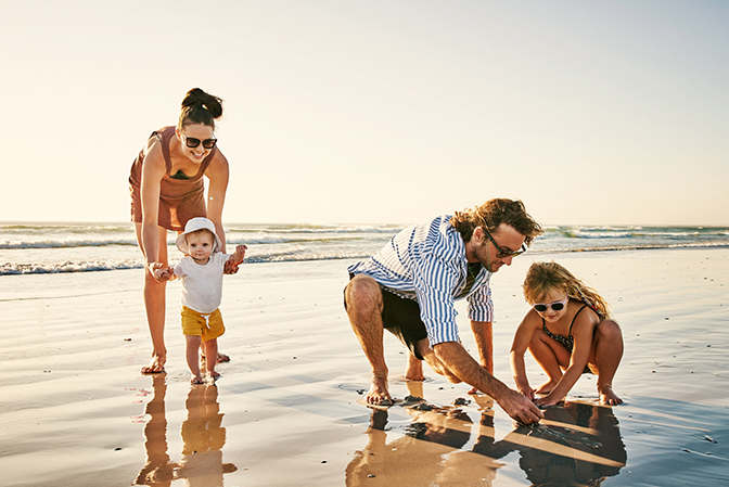 image of family on the beach