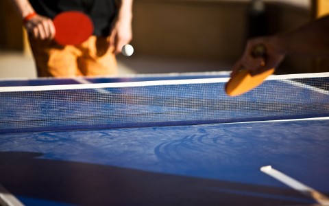 two people playing ping pong