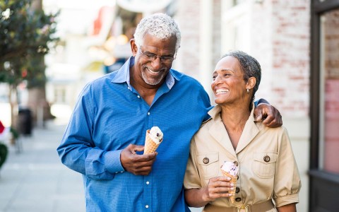 View of a lovely mature couple eating ice cream on the street