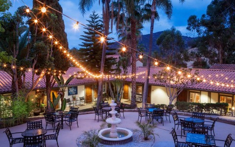 Aerial view of a beautiful outdoor dining area decorated with lightbulbs 