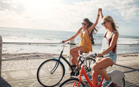 Two girl friends riding bikes at Catalina Island 
