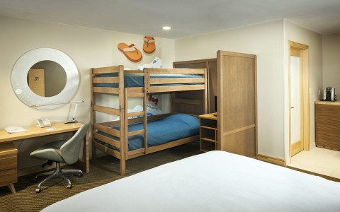 Internal view of a big room with a large bed and a bunk bed