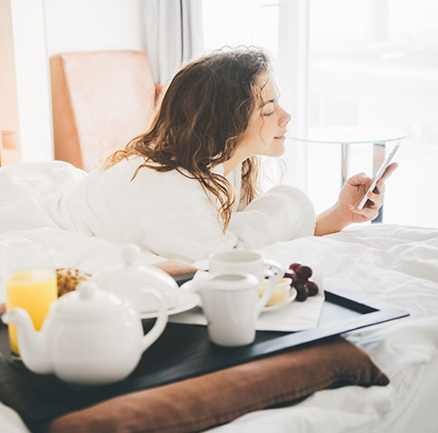 A woman having breakfast at bed