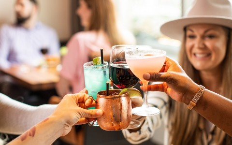 people toasting with their cocktails