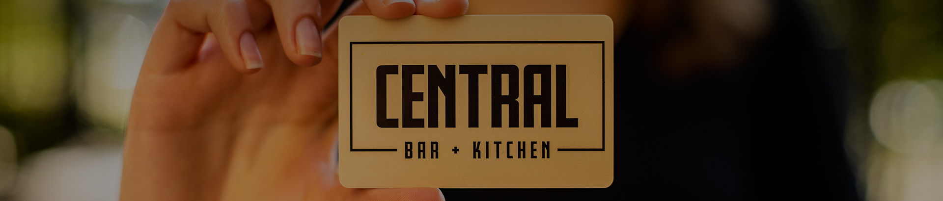 someone holding a central bar and kitchen card