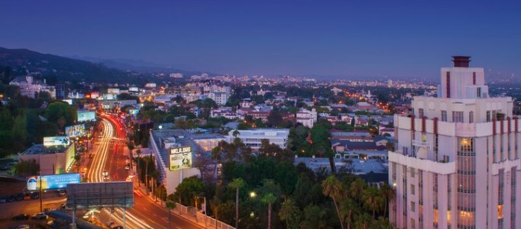 ariel view of quiet city street lit up by passing cars