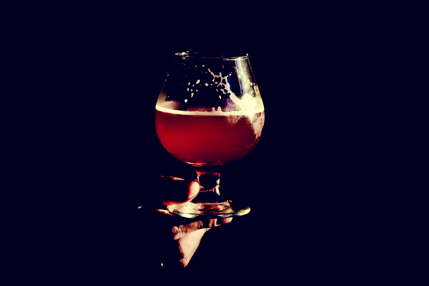 Hand Holding Glass of Beer