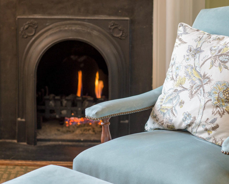 Charming Inns Fulton Lane Inn farmhouse light blue chair with fireplace