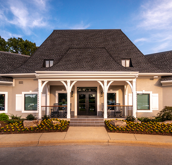 golf clubhouse with white pillars at the front