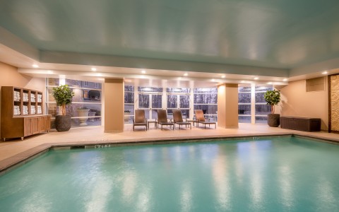 indoor pool with lounge seating