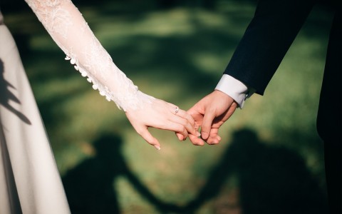 bride and groom holding hands