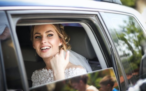 bride looking out of her car window