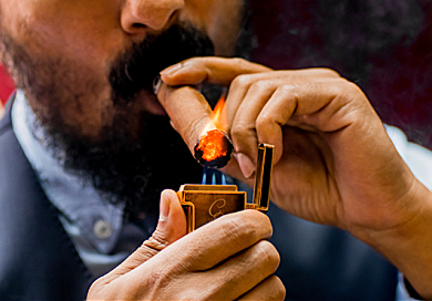 Man lighting cigar with a lighter