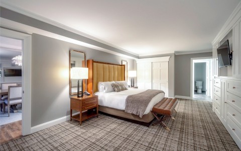 bed in room with a tv mounted on the wall