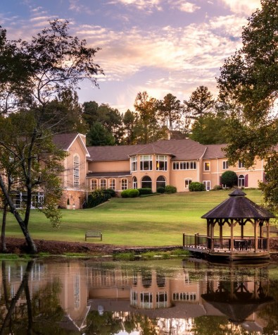 spa building and gazebo and trees from across the water