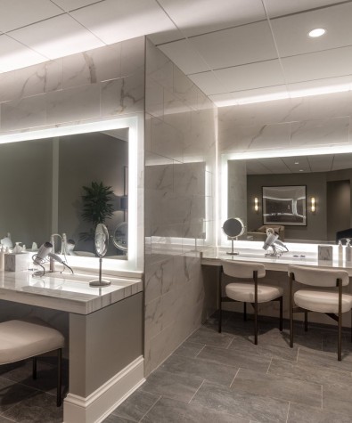 two vanities with backlit mirror, close-up mirrors and three chairs each