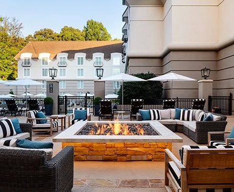fire pit by the pool surrounded with seating 