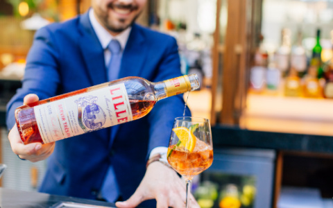 man pouring drink at bar