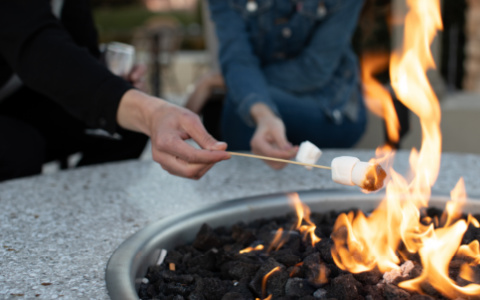 man roasting a marshmallow over an open flame
