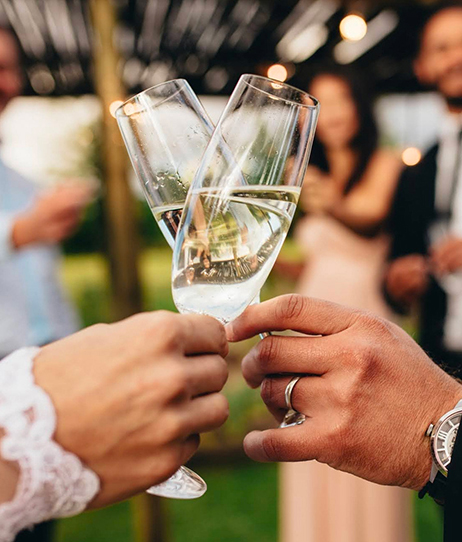 a bride and groom toasting glasses of champagne