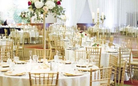 round tables at a wedding reception with flowers as centerpieces 