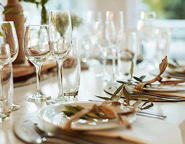 close up detail image of place settings with glasses in the background