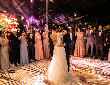 bride and groom dance in the middle of the crowd