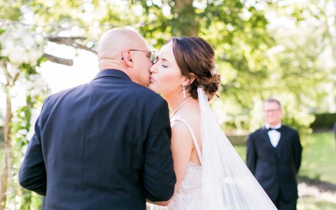 father kissing brides cheek