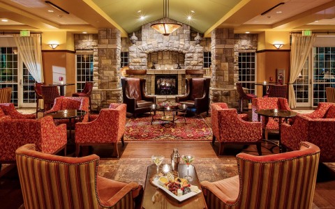 Lobby sitting area with chairs, coffee tables and fireplace 