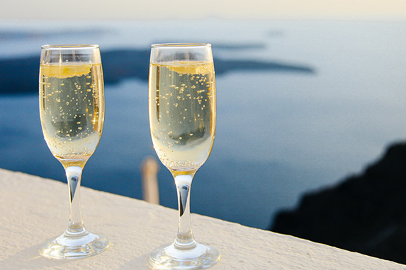 champagne fluets in front of water on balcony 