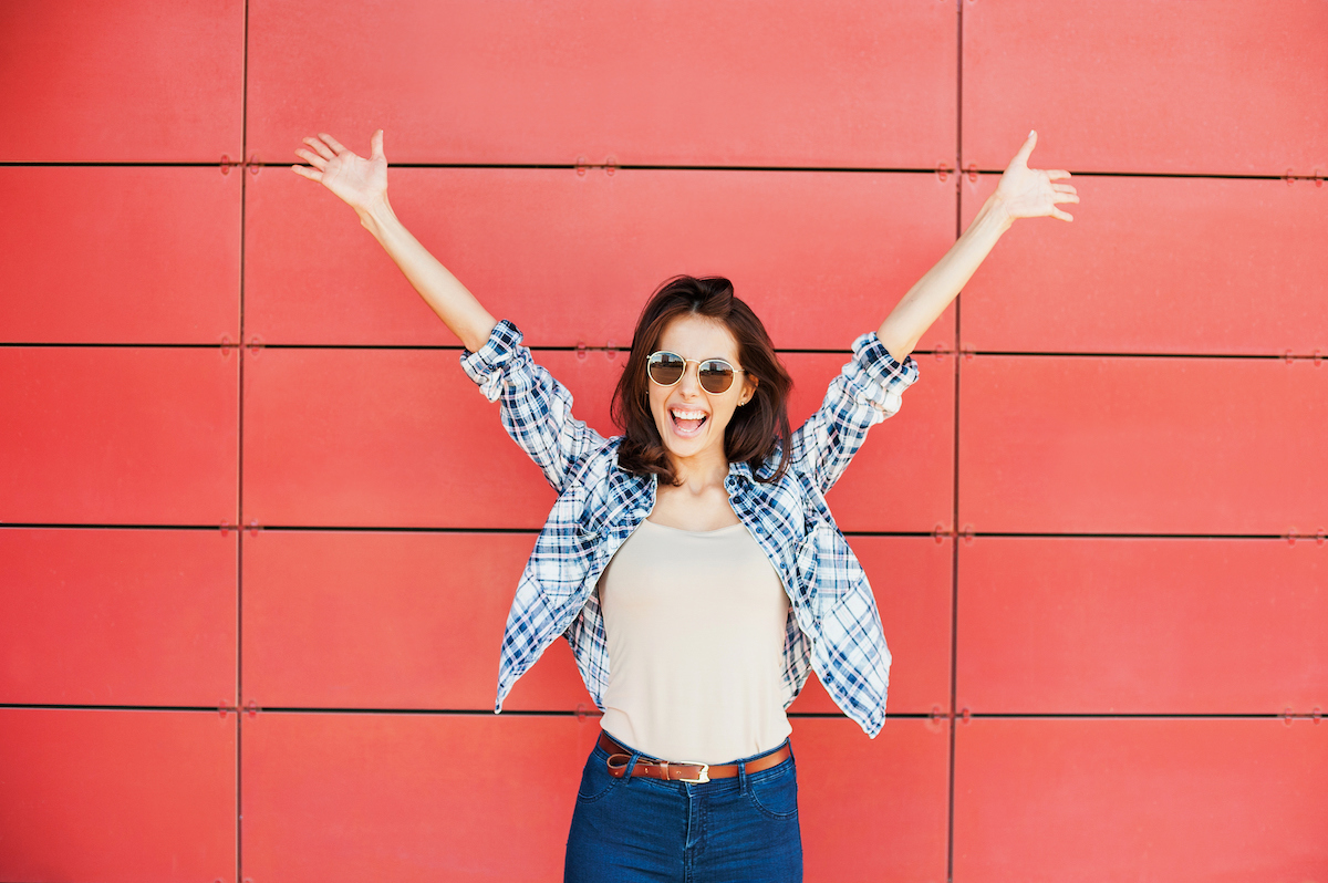 Girl in front of red wall