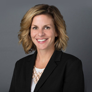 a woman in a suit smiling